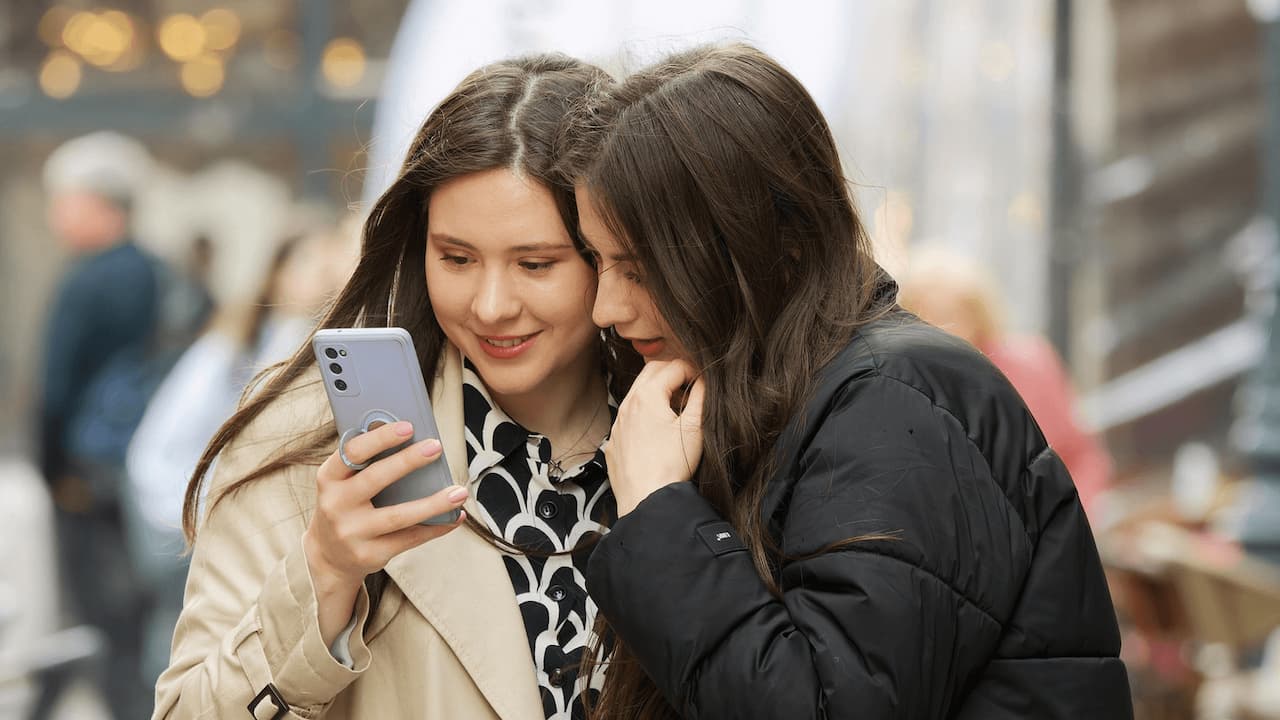 Dos-chicas-mirando-movil-linea-prepago-viaje Dos-chicas-mirando-movil-linea-prepago-viaje